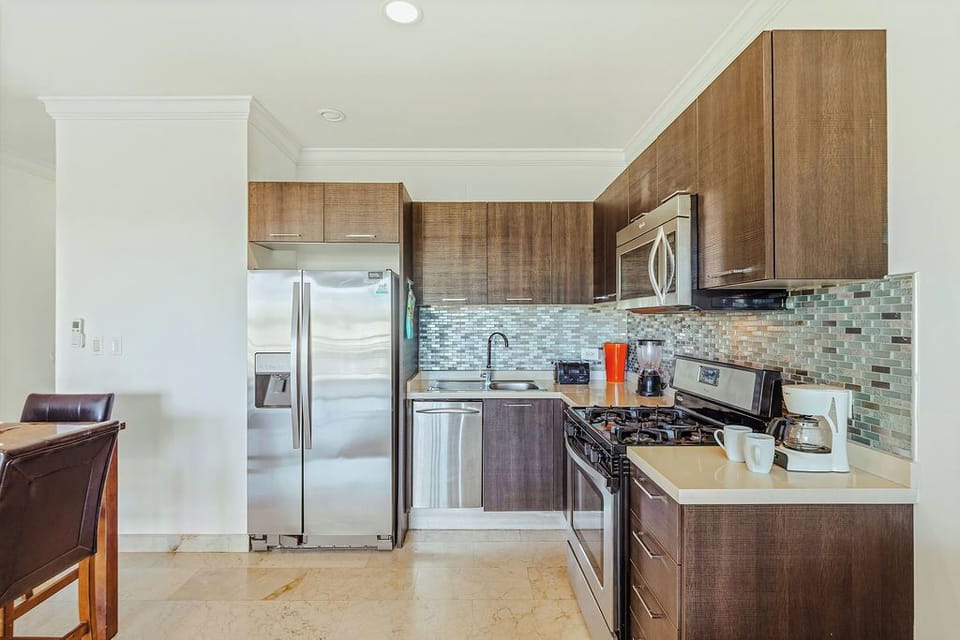 Fully equipped kitchen with stainless steel appliances, modern cabinetry, and everything you need to cook and dine comfortably.