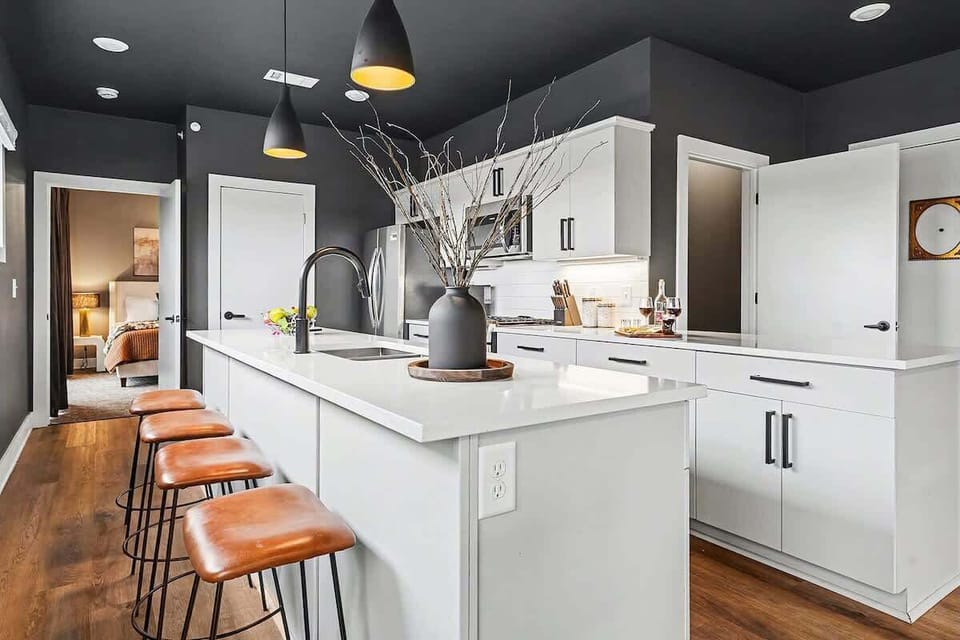 Fully equipped kitchen, complete with stainless-steel appliances and a kitchen island with ample counter space and bar seating.
