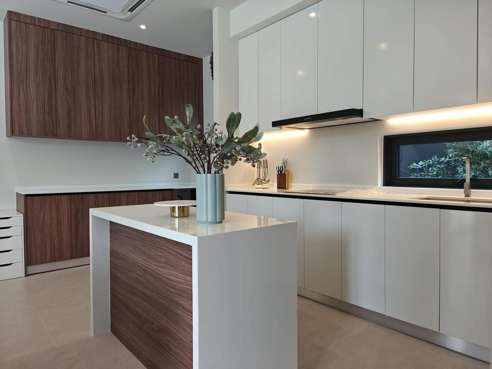 Fully equipped modern kitchen with a central island, premium finishes, and ample space for cooking and dining.