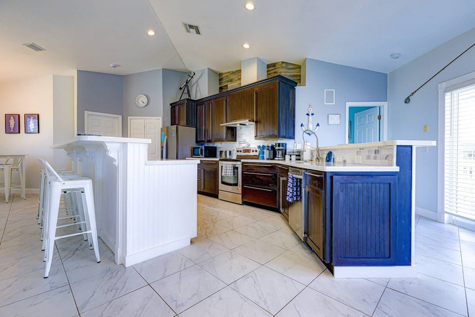 The spacious kitchen makes meal prep easy, giving family and friends plenty of room to gather and connect.