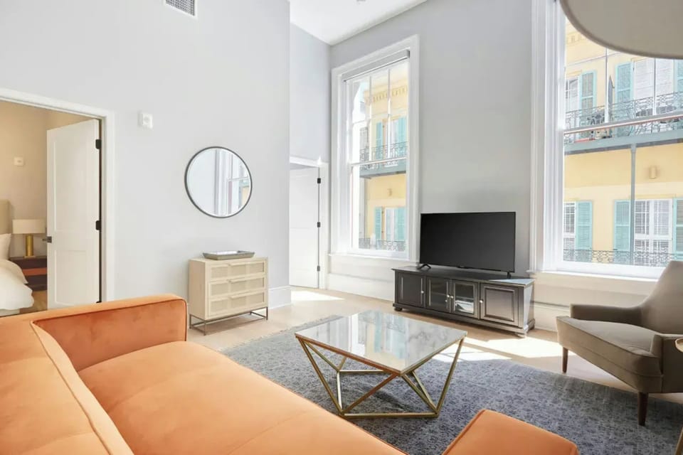 Living room with plush seating and a TV. (Unit 3)