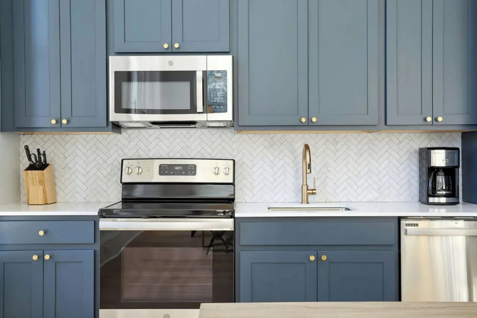 Unit 305: Kitchen features stainless steel appliances.