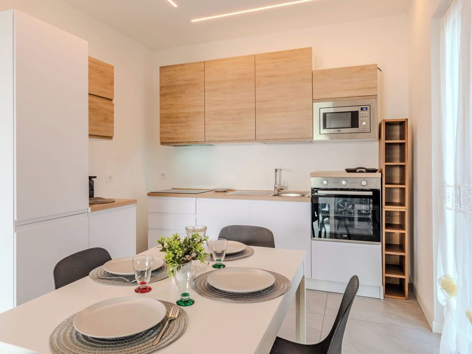 Furniture, Interior Design, Flooring, Wood, Countertop, Kitchen, Kitchen Appliance, Floor, Cabinetry, Room