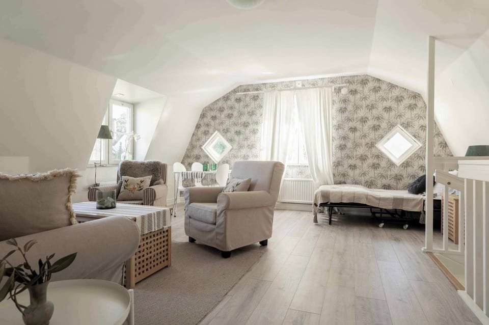 Cozy living room connected to the staircase leading to kitchen.