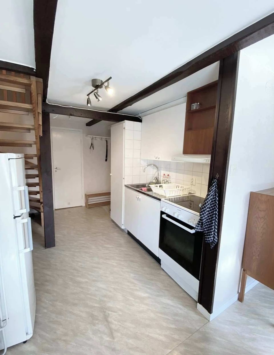 View towards the kitchen and stairs leading up to the loft with the bedroom.