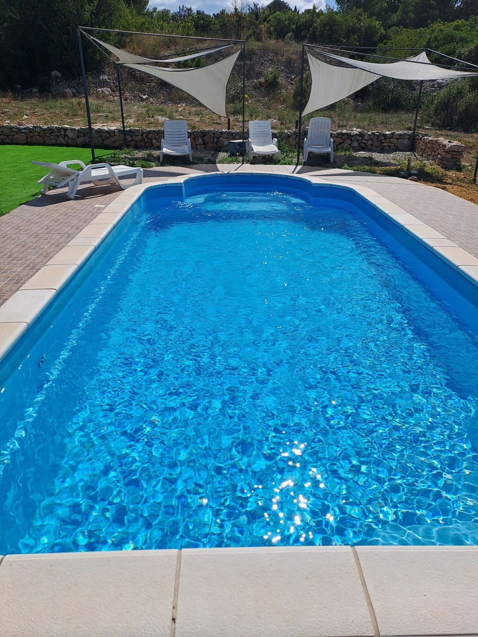 Outdoor pool, a heated pool, sun loungers
