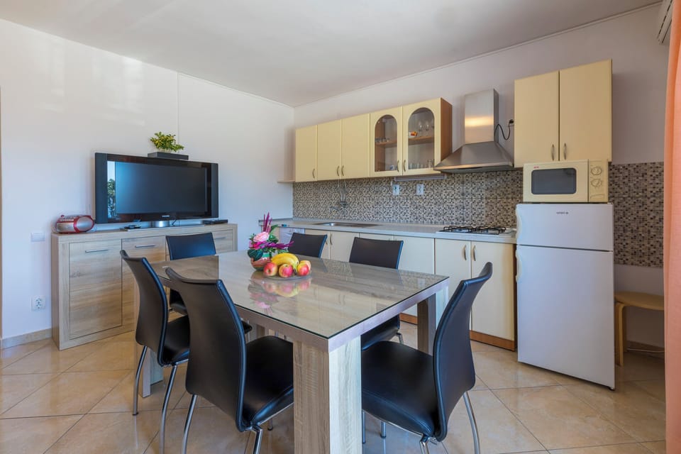 Apartment (A1) | Private kitchen | Fridge, microwave, stovetop, dishwasher
