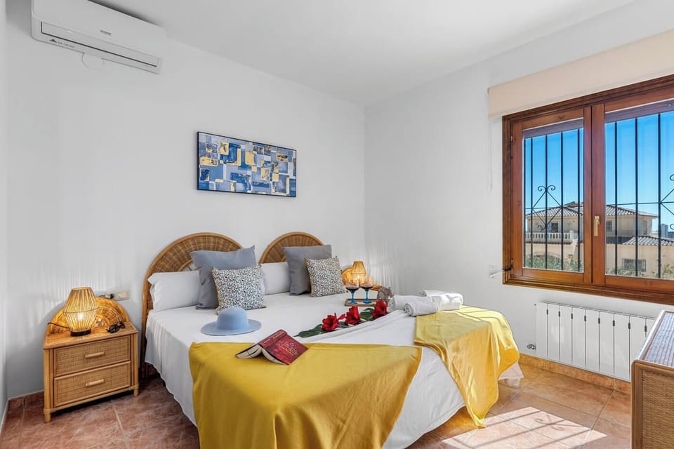We are pleased to present our charming villa with a private pool, located in Calpe, on the beautiful Costa Blanca. Accommodating up to 6 people, the villa has three bedrooms and three bathrooms. It also features air conditioning in the living-dining room and all bedrooms, as well as free Wi-Fi for your comfort.Inside, you'll find a spacious living-dining room with satellite TV and direct access to a covered terrace. The separate kitchen is fully equipped with a gas stove. Each bedroom has a double bed and a separate bathroom with a bathtub. Accessed via an interior staircase, the upper floor features a separate bathroom with a bathtub. You'll also find two bedrooms: one with a double bed and an en-suite bathroom with a shower, and the other with two single beds. From this floor, you can enjoy a charming terrace with stunning views of Calpe and the Mediterranean Sea.Outside, the villa offers a beautiful garden with an 8x4 meter pool and Roman steps. It also has an outdoor shower, a toilet, and a portable barbecue for enjoying your meals al fresco. The garage has space for one car, and the villa has additional parking for two vehicles on the same plot, which is completely fenced.The villa is located in the quiet Ortembach residential area, ideal for those seeking a relaxing and stress-free holiday. Despite its serene location, it is just 500 meters from the nearest supermarket, 2.8 km from the beach and restaurants, and 2.5 km from the center of Calpe.We hope you enjoy your stay in our cozy villa with private pool and sea views in Calpe. If you have any questions or need more information, please do not hesitate to contact us.We look forward to welcoming you soon!