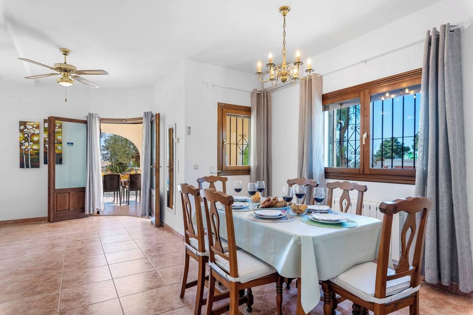 We are pleased to present our charming villa with a private pool, located in Calpe, on the beautiful Costa Blanca. Accommodating up to 6 people, the villa has three bedrooms and three bathrooms. It also features air conditioning in the living-dining room and all bedrooms, as well as free Wi-Fi for your comfort.Inside, you'll find a spacious living-dining room with satellite TV and direct access to a covered terrace. The separate kitchen is fully equipped with a gas stove. Each bedroom has a double bed and a separate bathroom with a bathtub. Accessed via an interior staircase, the upper floor features a separate bathroom with a bathtub. You'll also find two bedrooms: one with a double bed and an en-suite bathroom with a shower, and the other with two single beds. From this floor, you can enjoy a charming terrace with stunning views of Calpe and the Mediterranean Sea.Outside, the villa offers a beautiful garden with an 8x4 meter pool and Roman steps. It also has an outdoor shower, a toilet, and a portable barbecue for enjoying your meals al fresco. The garage has space for one car, and the villa has additional parking for two vehicles on the same plot, which is completely fenced.The villa is located in the quiet Ortembach residential area, ideal for those seeking a relaxing and stress-free holiday. Despite its serene location, it is just 500 meters from the nearest supermarket, 2.8 km from the beach and restaurants, and 2.5 km from the center of Calpe.We hope you enjoy your stay in our cozy villa with private pool and sea views in Calpe. If you have any questions or need more information, please do not hesitate to contact us.We look forward to welcoming you soon!