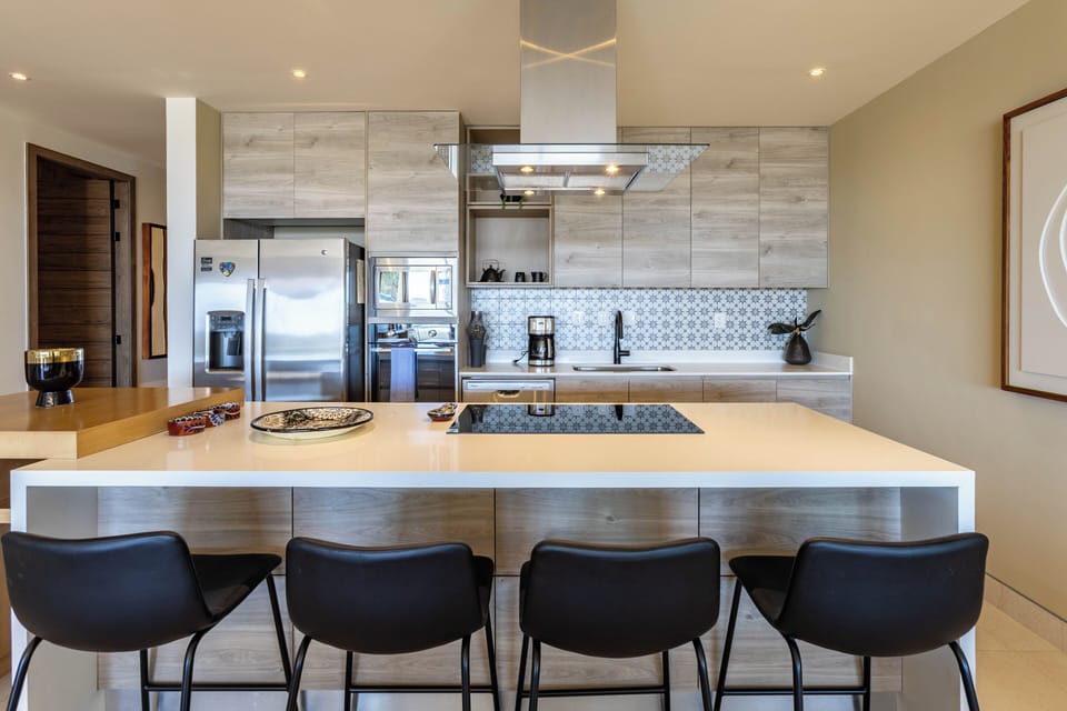Fully equipped kitchen with counter seating, ideal for casual meals and entertaining.
