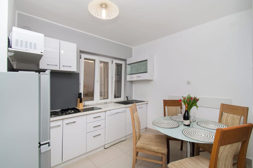 Apartment (A1) | Private kitchen | Fridge, microwave, stovetop, dishwasher