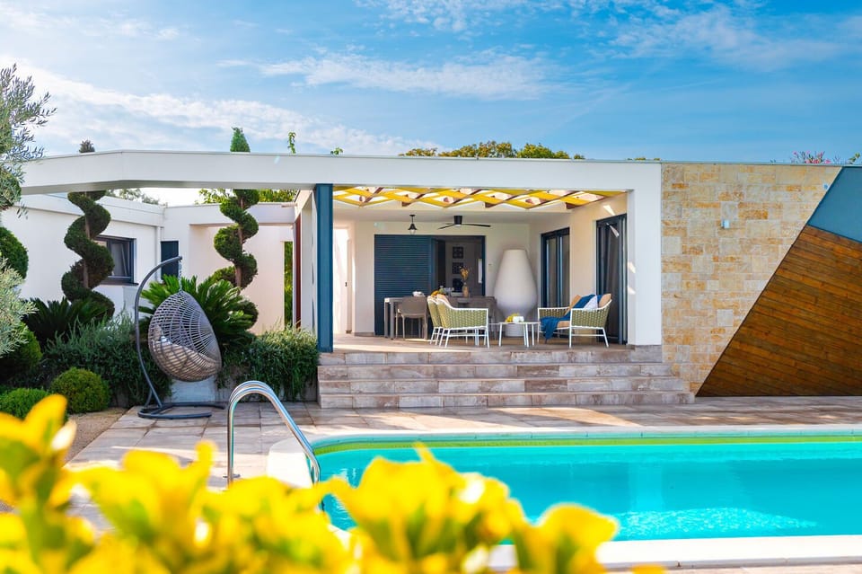 Outdoor pool, a heated pool, open open 24 hours, pool umbrellas