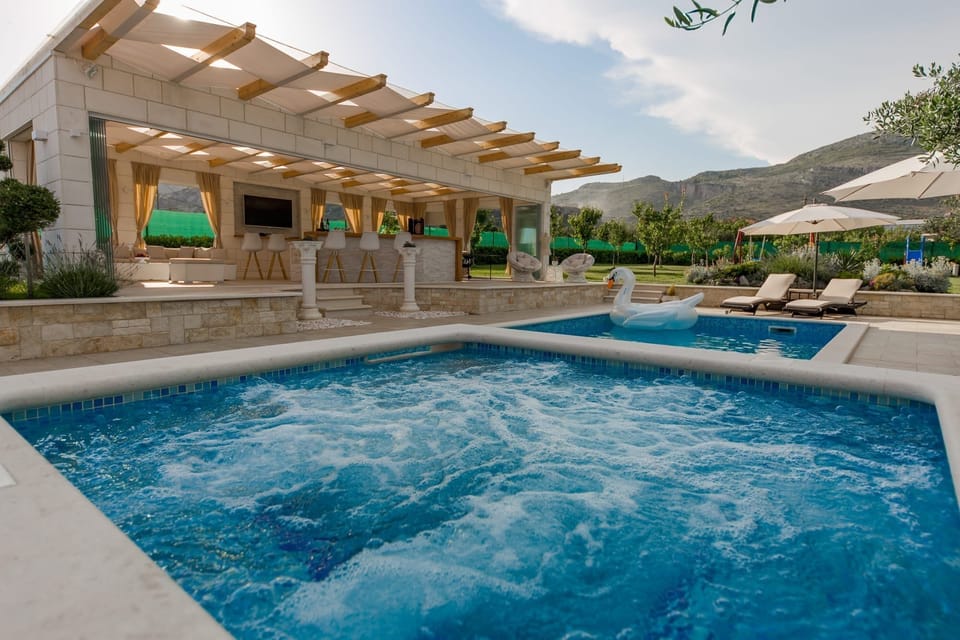 Outdoor pool, a heated pool, pool umbrellas