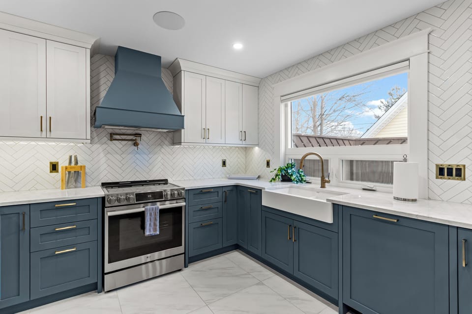 Culinary perfection featuring a professional-grade range, custom range hood, pot filler, and a large farmhouse sink.