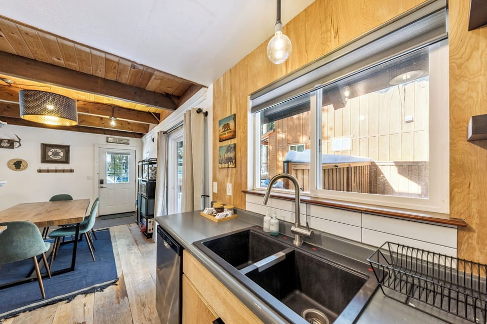 Your modern kitchen features warm wood cabinetry and flows seamlessly into the cozy dining area—perfect for preparing meals together.