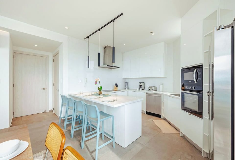 Your modern kitchen awaits with sleek cabinetry, stainless steel appliances, and a bright island perfect for sharing meals or morning coffee together.