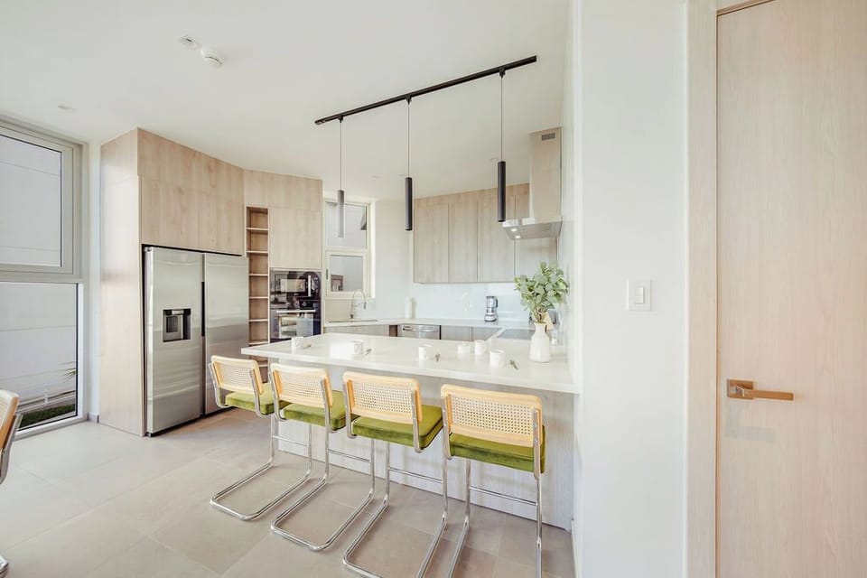 Picture yourself starting your morning here—fresh coffee, sunlight streaming in, and a sleek kitchen island perfect for quick meals or evening conversations with loved ones.