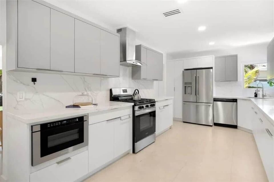 Cook in this sleek kitchen with modern appliances, minimalist design, and natural light. Perfect for guests who enjoy stylish, functional spaces.