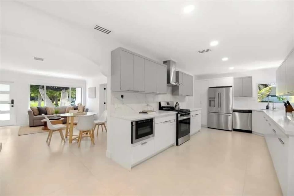Cook, dine, and unwind in this bright, open-concept space—featuring a sleek kitchen, cozy dining area, and sunlit living zone. Perfect for vacation rental guests who love clean design, natural light, and modern comfort. Your stylish stay begins here!