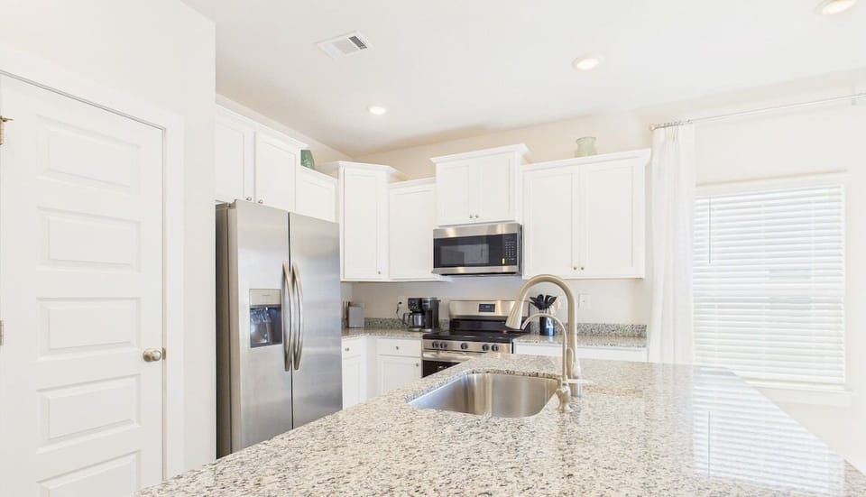 Cook with ease in this bright, fully-equipped kitchen featuring granite counters, stainless appliances, and everything you need for memorable meals.