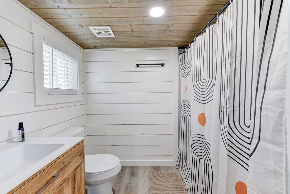 The bathroom has a walk in shower