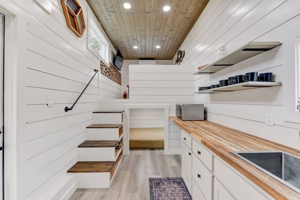 The living room and first bedroom are on the left side of the kitchenette