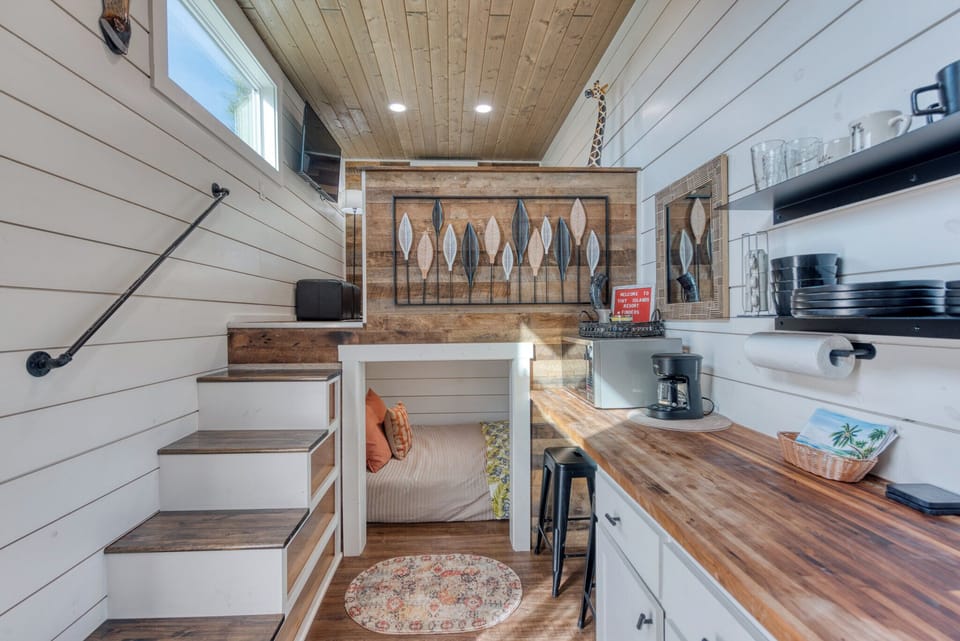 The living room, and bedroom one are at the left end of the kitchenette