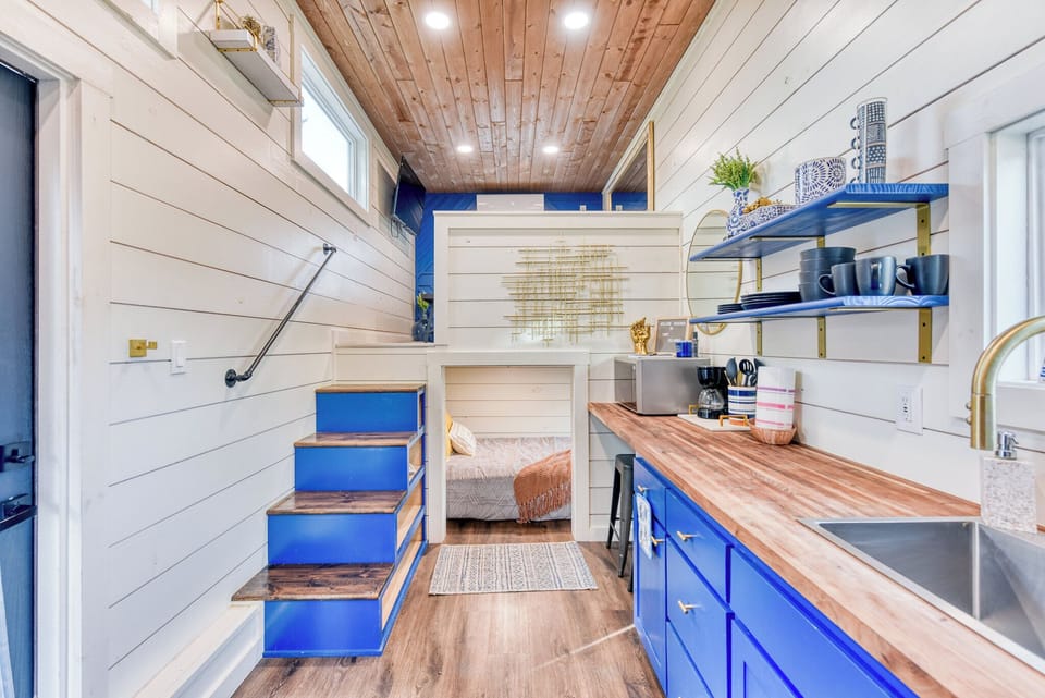 The living room and first bedroom are on the left side of the kitchenette