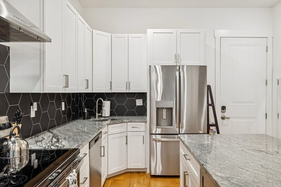 Fully stocked kitchen with stainless steel appliances and all you`d need to make a home cooked meal
