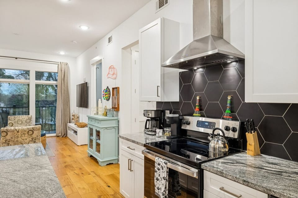 Fully stocked kitchen with stainless steel appliances and all you`d need to make a home cooked meal