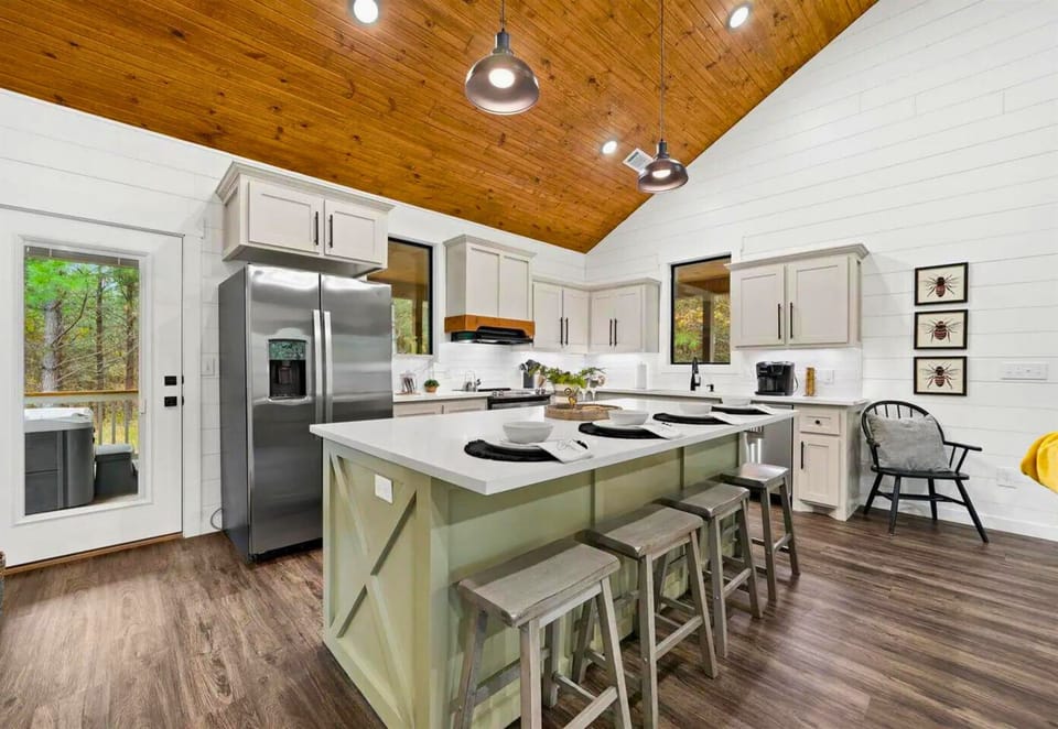 Gather around this spacious kitchen island where your group can cook together under warm wood ceilings and forest views.