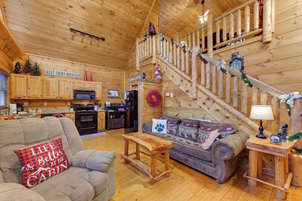Cozy up in your rustic mountain retreat with warm wood walls, comfortable sofas, and charming cabin decor that makes every moment feel magical.