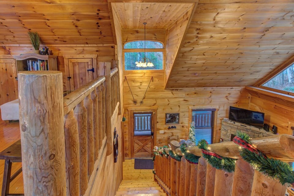 Rustic log cabin charm surrounds you with warm wood details, cozy seating, and mountain views through every window.
