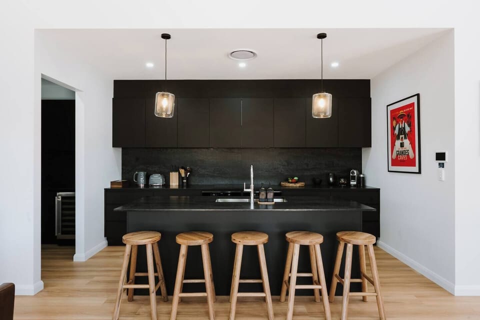 Cook with ease in a sleek, contemporary kitchen featuring quality appliances, generous bench space and a layout for easy preparation and connection.
