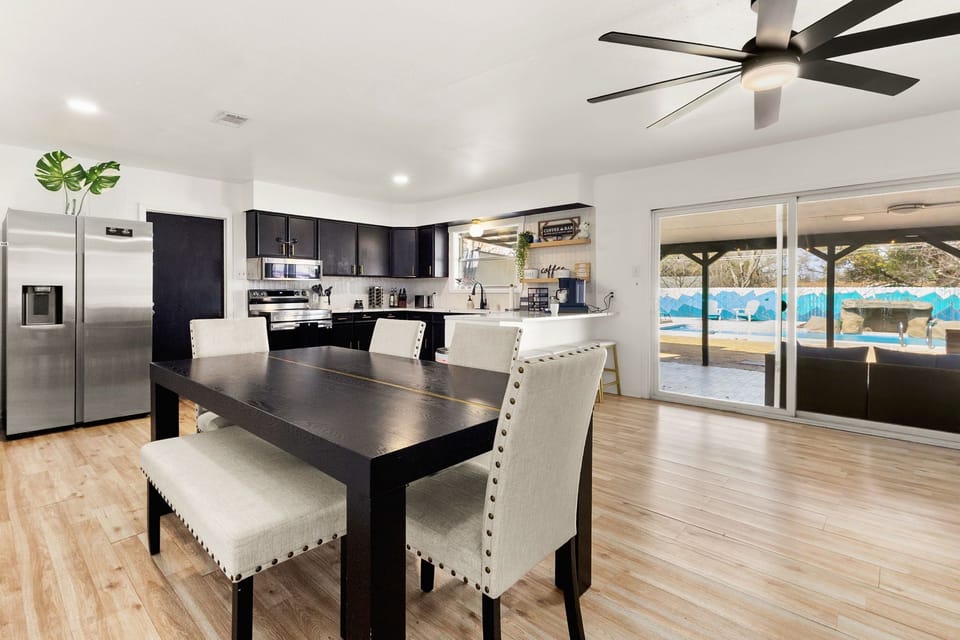 Open dining and kitchen space with backyard views perfect for gathering