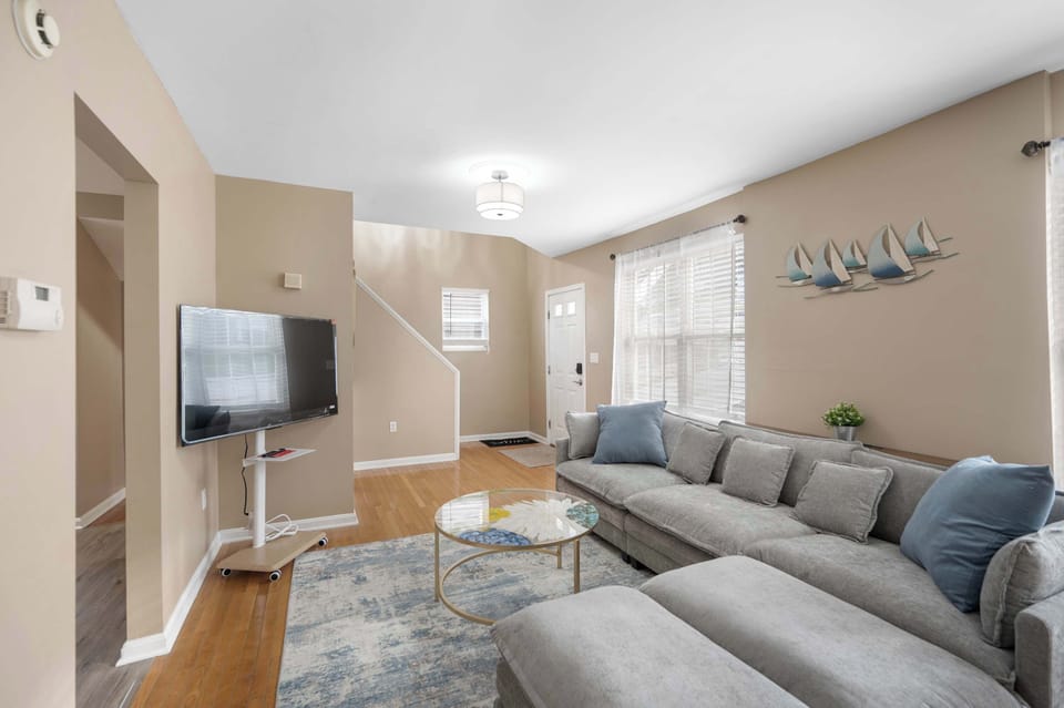 Enjoy the bright living room with a large couch and smart TV