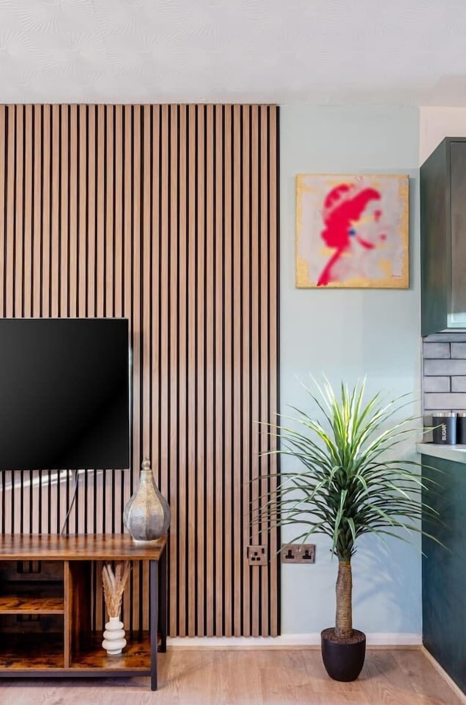 Interior design detail and plant next to TV