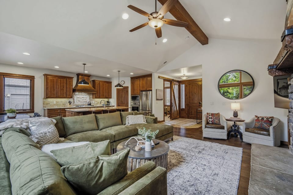 Unwind in your spacious open-concept retreat with exposed wood beams and cozy sectional seating.