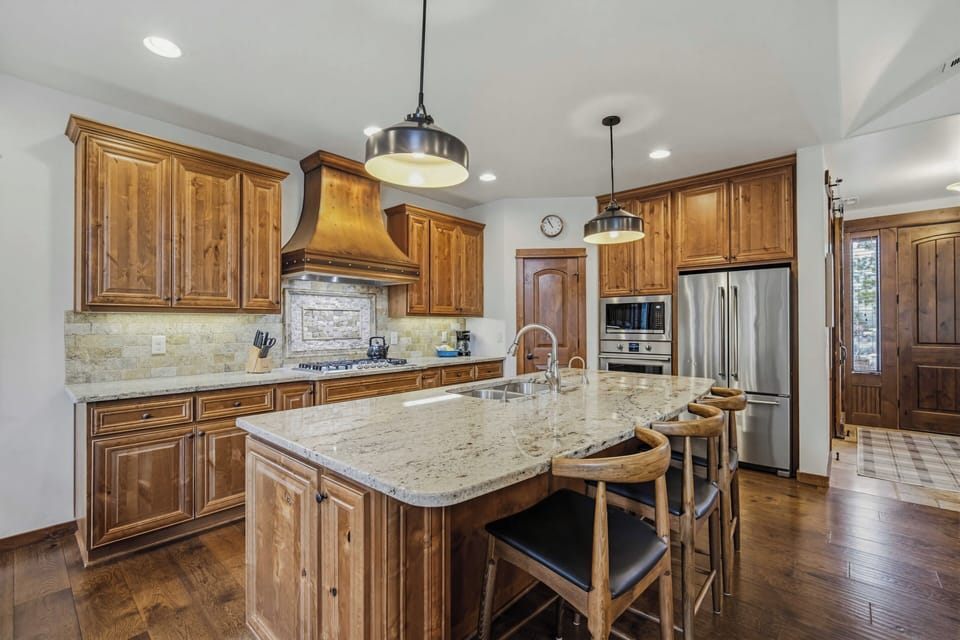 Your fully equipped gourmet kitchen awaits with granite counters, stainless appliances, and a breakfast island perfect for morning coffee or evening wine.