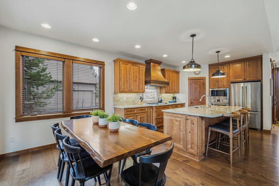 Your stunning kitchen features rich wood cabinetry, granite countertops, and stainless steel appliances, creating the perfect space for memorable meals together.