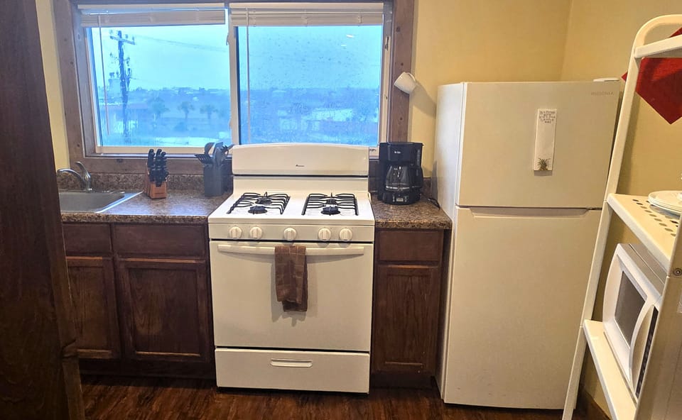 A drip coffee maker and basic kitchenware and soaps are provided.