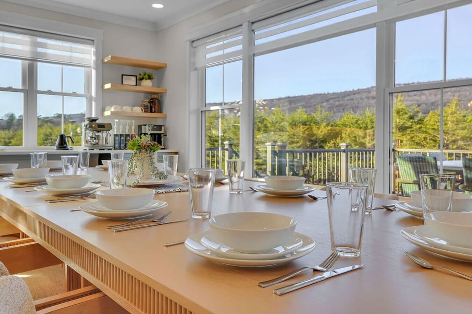 Dining Area seats 12, with 7 additional barstools, and outside the double doors additional seating on balcony.