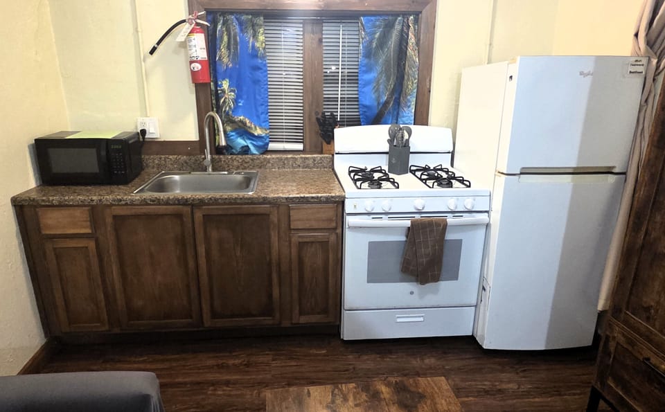 The studio features a full kitchen with a gas stove and refrigerator.