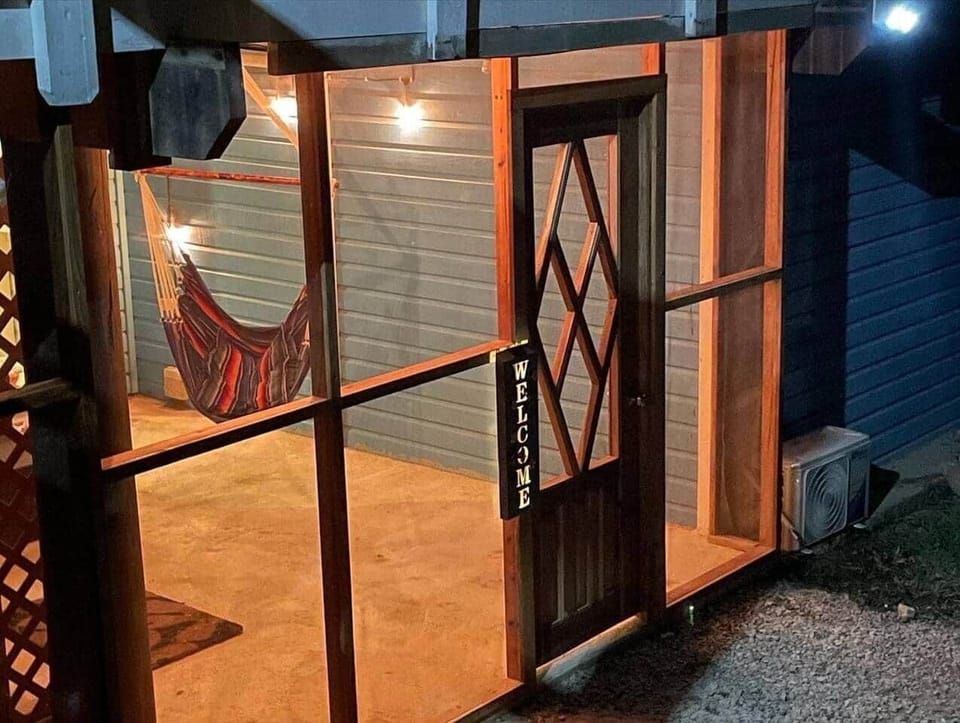 Screened patio for comfortable outdoor time day and night.  Area has an outdoor shower, bistro set and hammock.