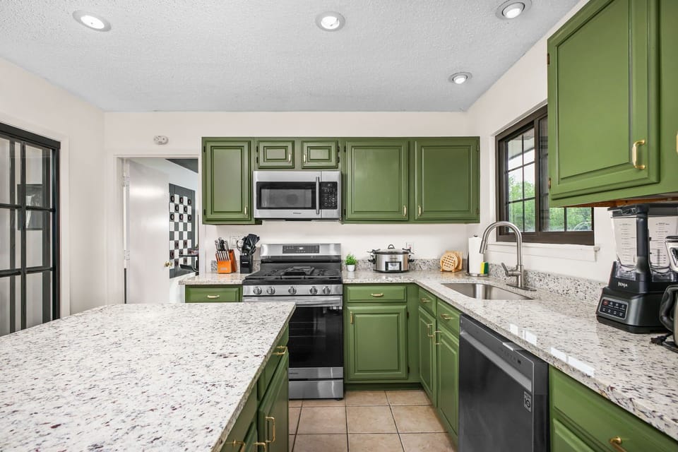 Featuring high-end appliances, abundant cabinetry, and a spacious island with high seating—perfect for both cooking and entertaining.
