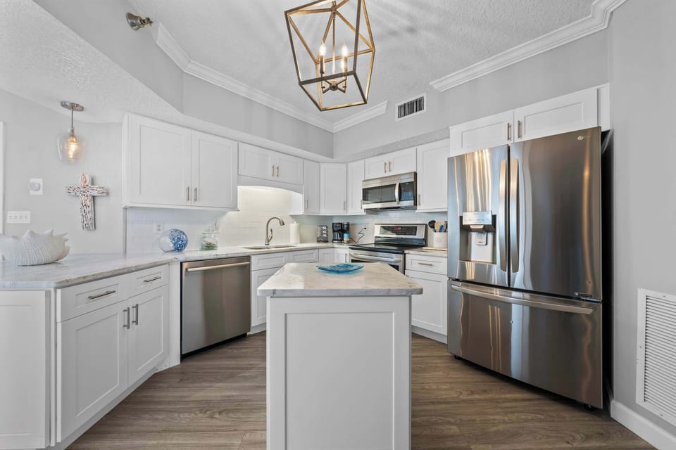 Open, bright, and ready to serve—our kitchen is basically an invitation to gather, laugh, and eat your way through vacation.