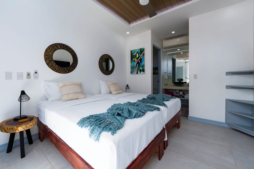 Comfortable bedroom with twin beds or king setup, private bath, and TV