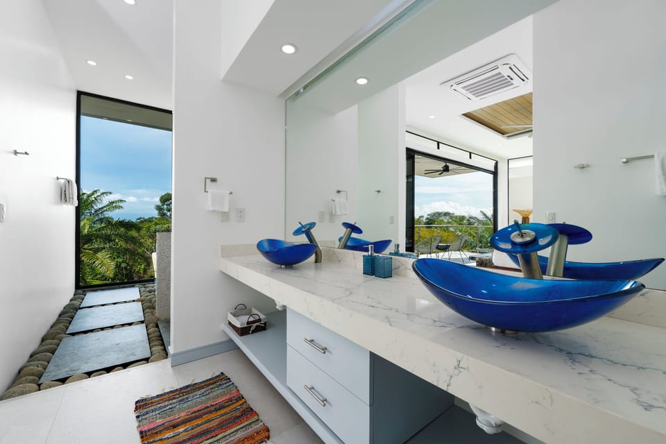 Primary suite bathroom with walk-in shower and serene, spa-style design.