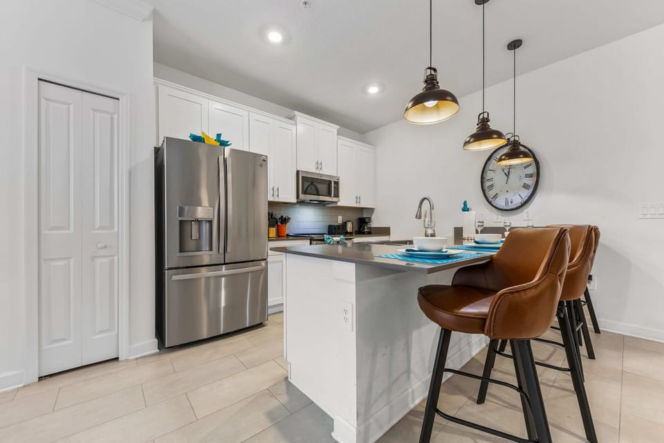 Chef-ready kitchen with stainless appliances, white shaker cabinets, and a breakfast bar for three-perfect for coffee, snacks, and conversation!