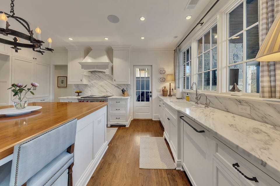 Bright kitchen w/ hardwood floors & ample counter space for cooking